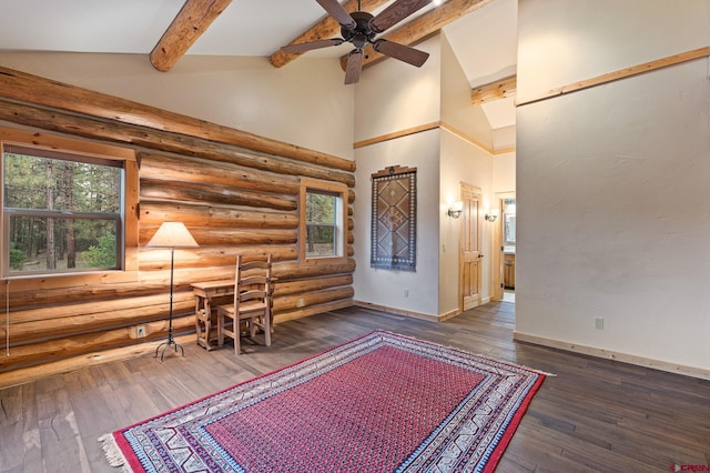 unfurnished room with lofted ceiling with beams, ceiling fan, and dark wood-type flooring