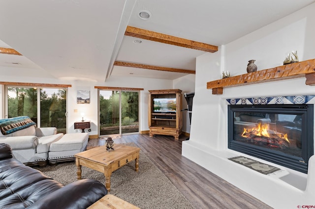 living room featuring beamed ceiling and dark wood-type flooring