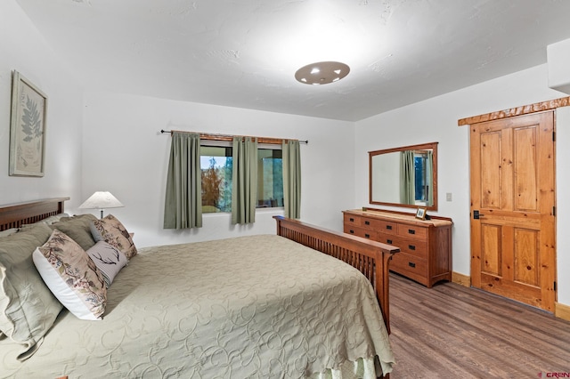 bedroom with hardwood / wood-style flooring