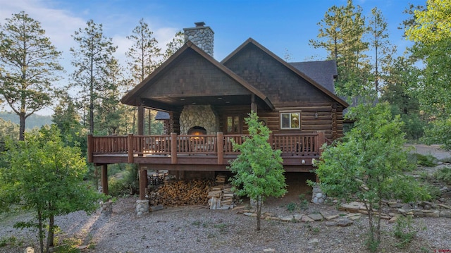 back of property featuring a wooden deck