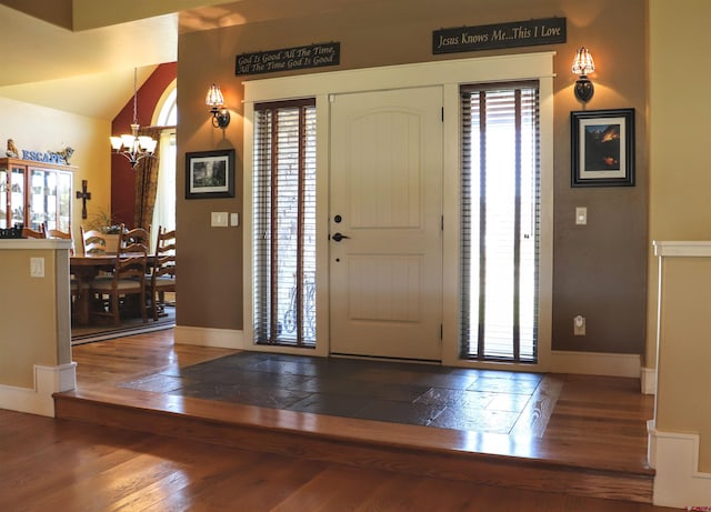 entrance foyer featuring hardwood / wood-style floors and a notable chandelier