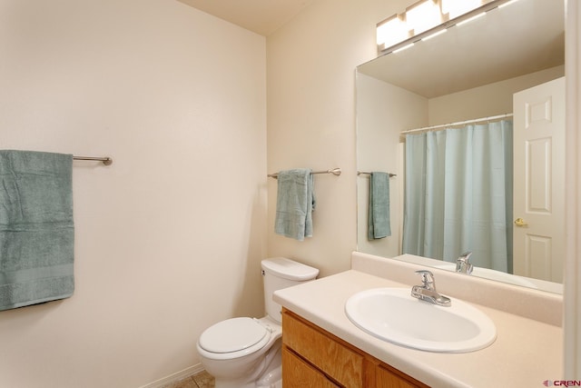 bathroom featuring vanity, toilet, and tile patterned floors