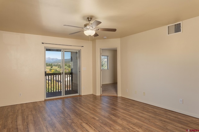 spare room featuring ceiling fan and dark hardwood / wood-style flooring