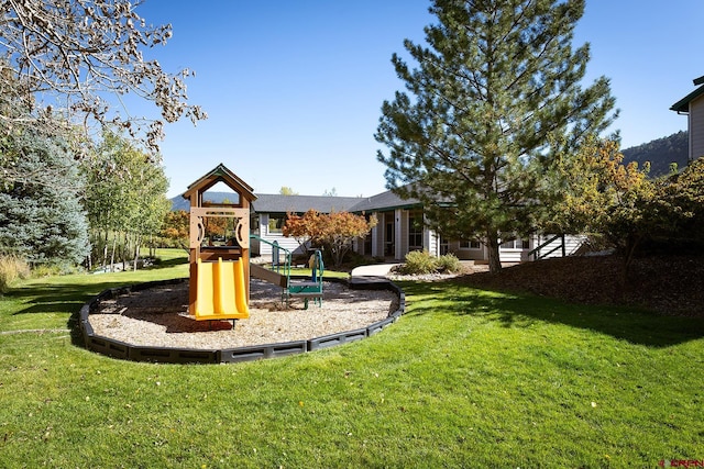 view of playground with a lawn