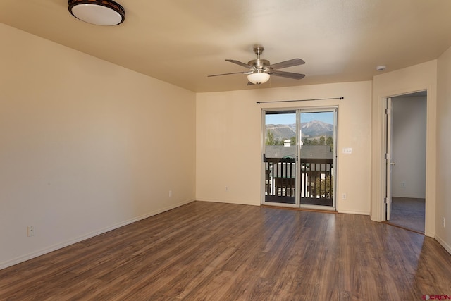 spare room with ceiling fan and dark hardwood / wood-style flooring