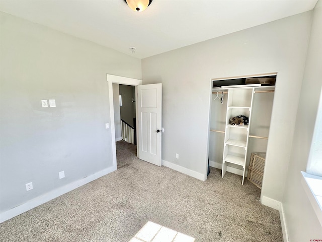 unfurnished bedroom with carpet floors and a closet