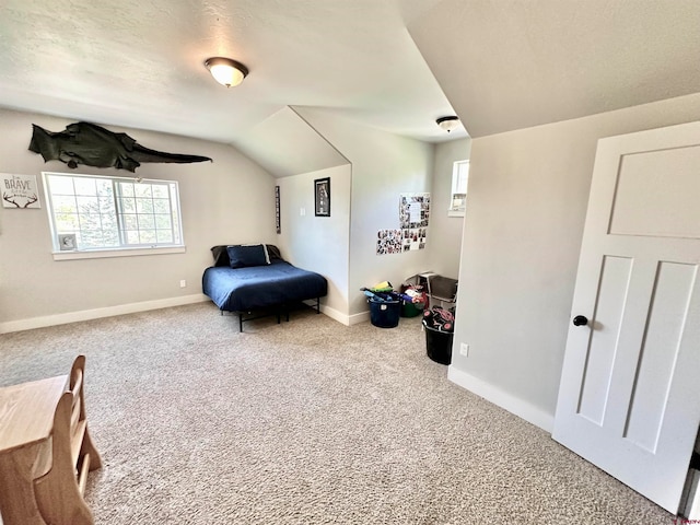 bedroom with carpet floors, a textured ceiling, and lofted ceiling