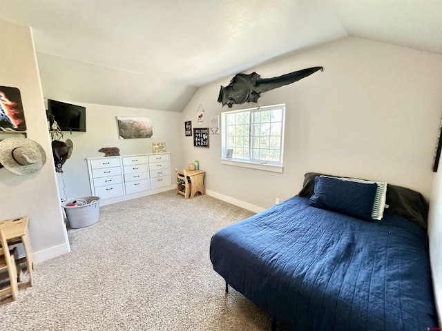 carpeted bedroom featuring baseboards and lofted ceiling