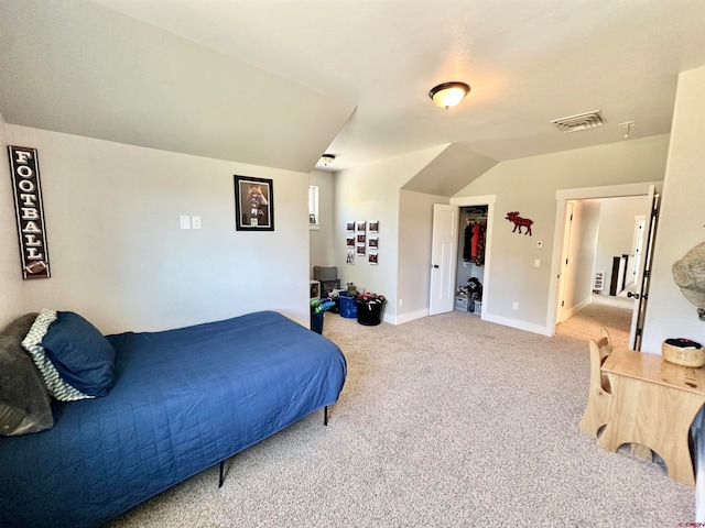 carpeted bedroom with lofted ceiling and a closet