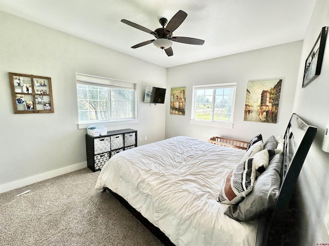 carpeted bedroom featuring baseboards and a ceiling fan