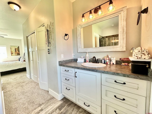 bathroom featuring vanity, ceiling fan, and hardwood / wood-style flooring