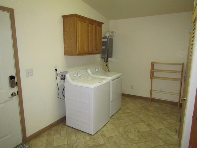 washroom with cabinets, water heater, and washer and dryer