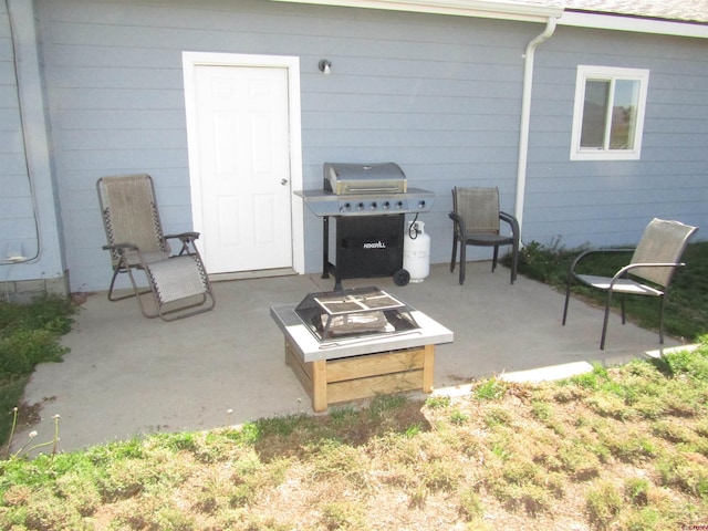 view of patio / terrace with grilling area and a fire pit