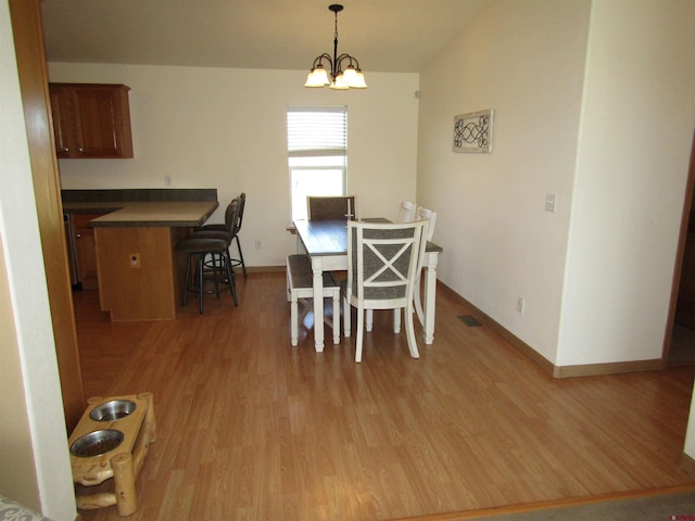 dining room featuring light hardwood / wood-style flooring and a chandelier