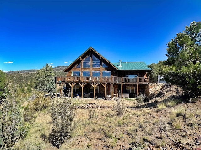 back of property featuring a wooden deck