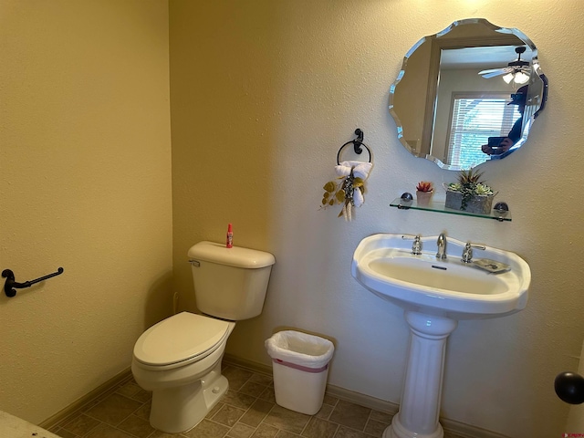 bathroom with ceiling fan and toilet