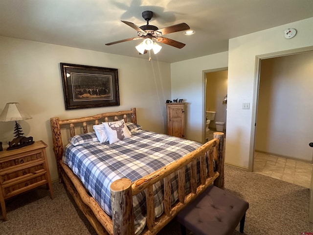 bedroom featuring carpet floors, ceiling fan, and ensuite bathroom