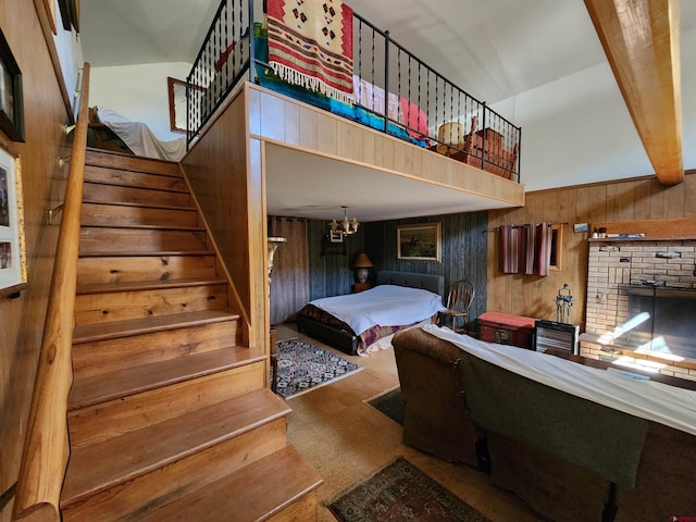 stairway featuring wooden walls, a fireplace, and a towering ceiling