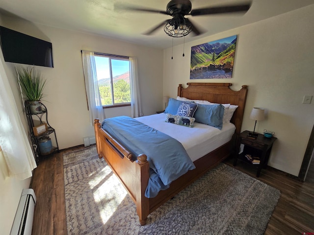 bedroom featuring a baseboard radiator, ceiling fan, and dark wood-type flooring