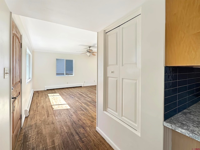 interior space featuring baseboard heating and hardwood / wood-style flooring