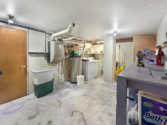 basement featuring water heater and washing machine and dryer