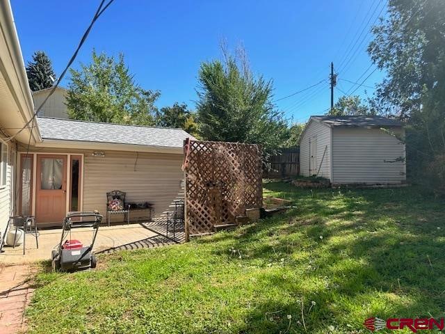 view of yard featuring a shed and a patio area