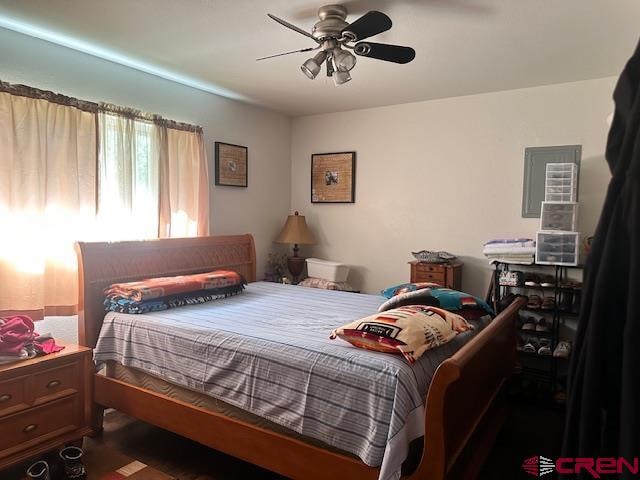 bedroom with ceiling fan and dark wood-type flooring