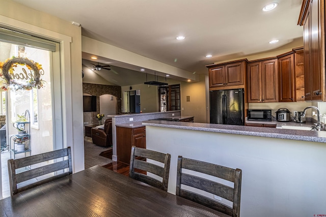 kitchen with kitchen peninsula, black appliances, ceiling fan, dark hardwood / wood-style floors, and sink