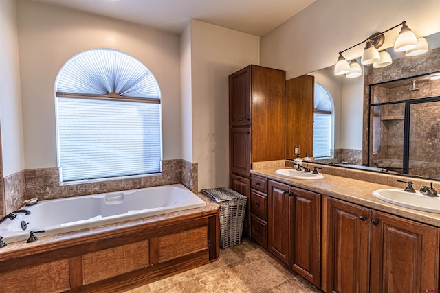 bathroom with vanity, separate shower and tub, and a healthy amount of sunlight