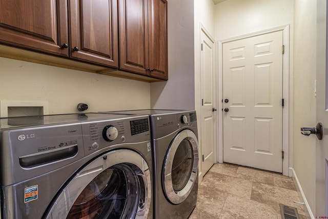 laundry room featuring cabinets and independent washer and dryer