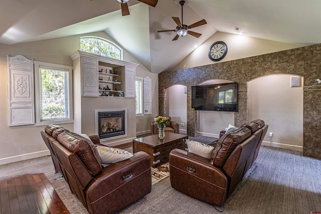 living room with high vaulted ceiling, ceiling fan, and hardwood / wood-style flooring