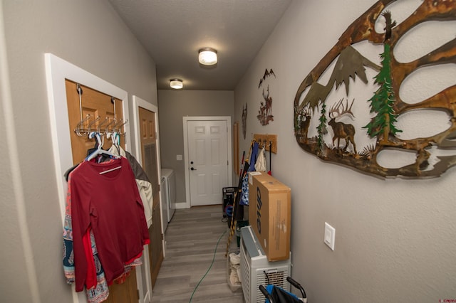 145 Lassen Dr, Pagosa Springs, CO 81147 - doorway featuring a textured ceiling, washer and dryer, and hardwood / wood-style flooring