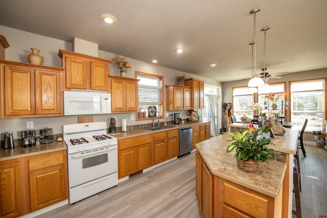 145 Lassen Dr, Pagosa Springs, CO 81147 - kitchen featuring light hardwood / wood-style floors, sink, white appliances, decorative light fixtures, and ceiling fan