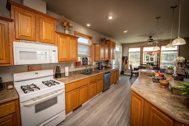 145 Lassen Dr, Pagosa Springs, CO 81147 - kitchen featuring white appliances, pendant lighting, light wood-type flooring, ceiling fan, and sink