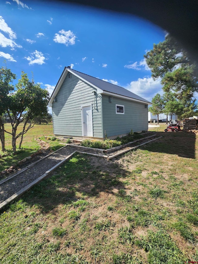 view of property exterior with a yard