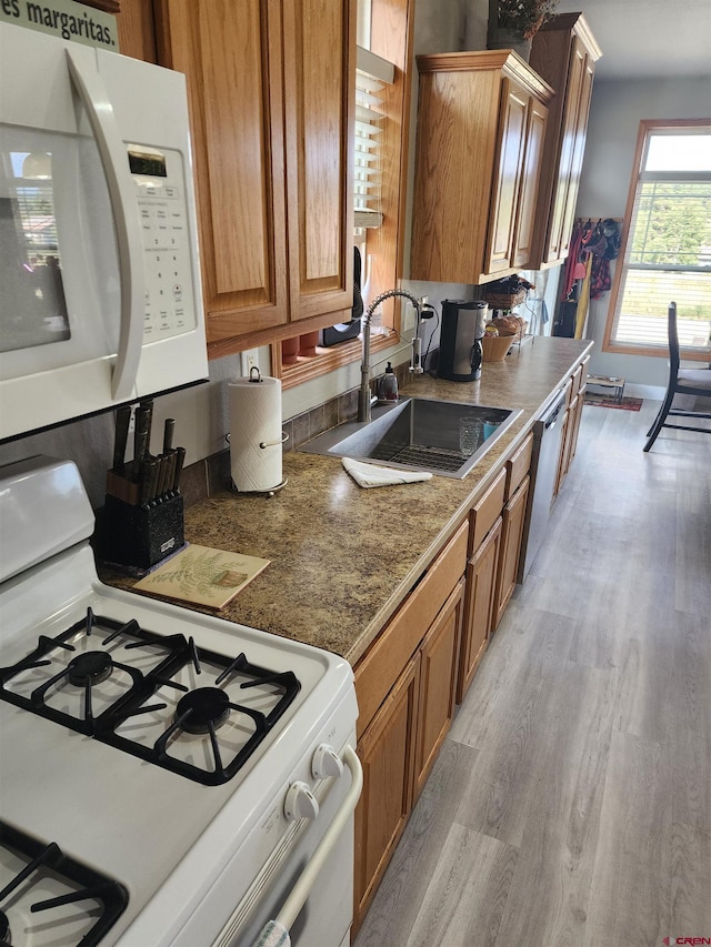 145 Lassen Dr, Pagosa Springs, CO 81147 - kitchen with light wood-type flooring, white appliances, and sink