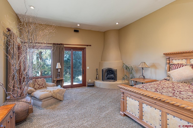 carpeted bedroom with a large fireplace