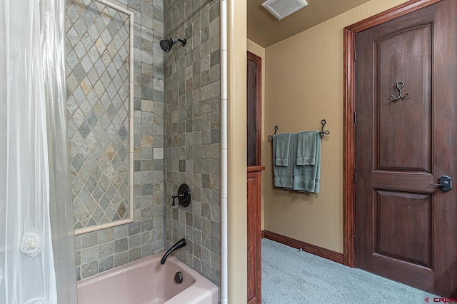 bathroom with shower / bath combo with shower curtain