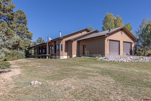 view of side of property with a yard and a garage