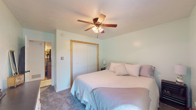 bedroom with ceiling fan, a textured ceiling, a closet, and carpet flooring