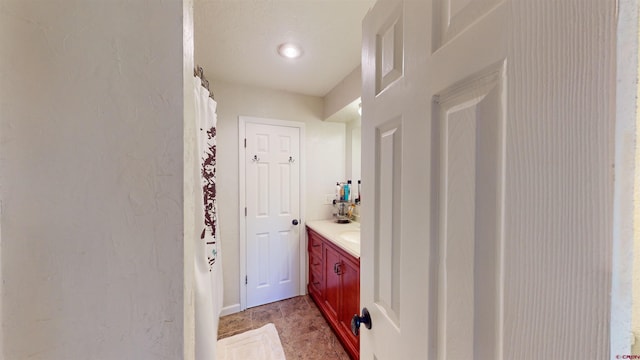 bathroom featuring vanity and curtained shower