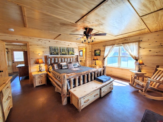 bedroom with ceiling fan and wood walls