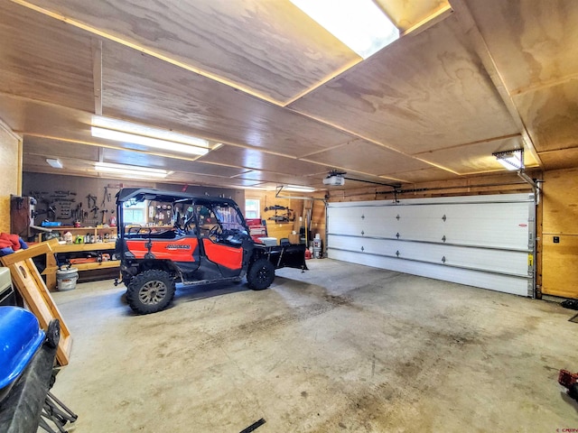 garage featuring a garage door opener and a workshop area