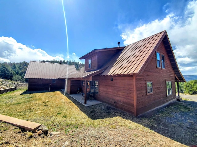 view of property exterior featuring a yard and a patio area