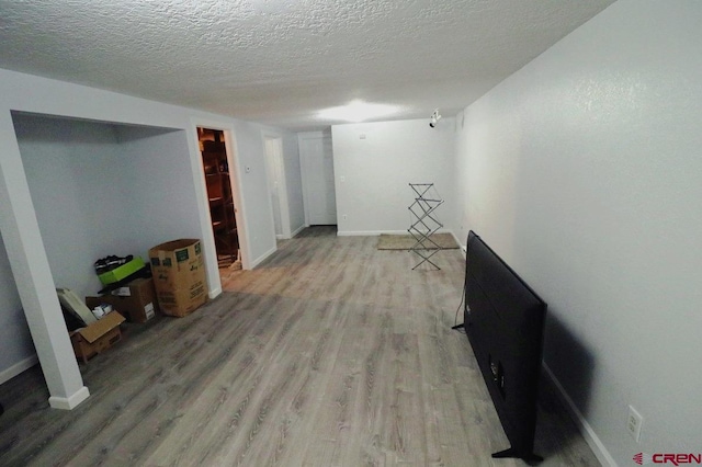 basement with a textured ceiling and wood-type flooring