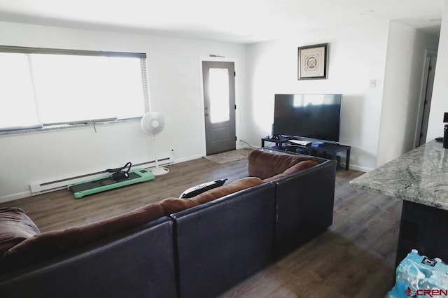 living room with baseboard heating and dark hardwood / wood-style flooring