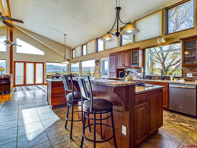 kitchen with high vaulted ceiling and a center island