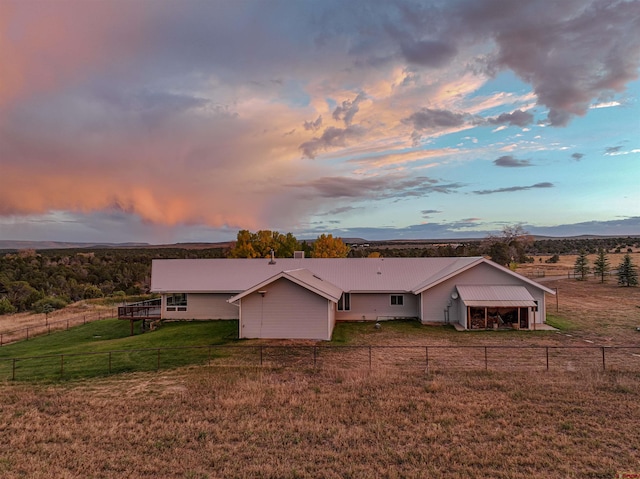 view of front of home with a mountain view, a rural view, and a yard