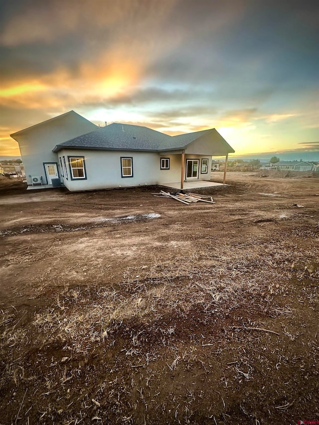 view of back house at dusk