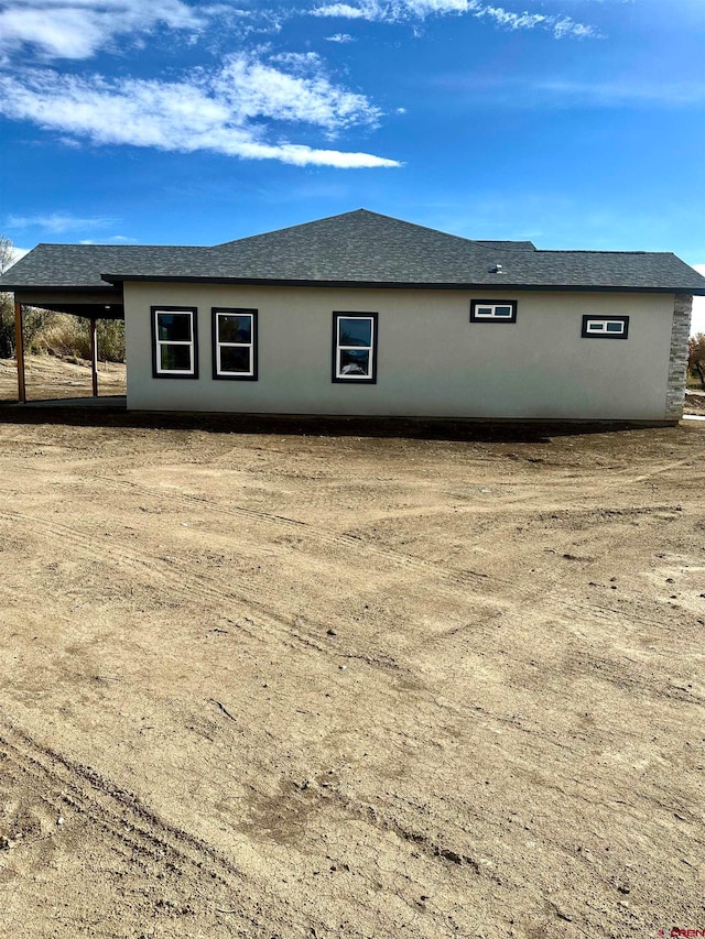 view of home's exterior with a carport